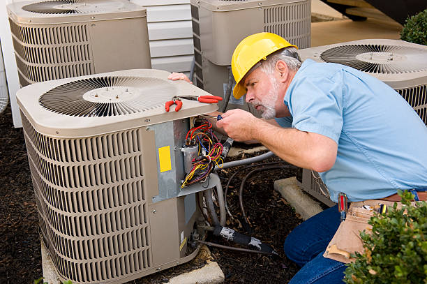 techncian working on ac unit with his tools