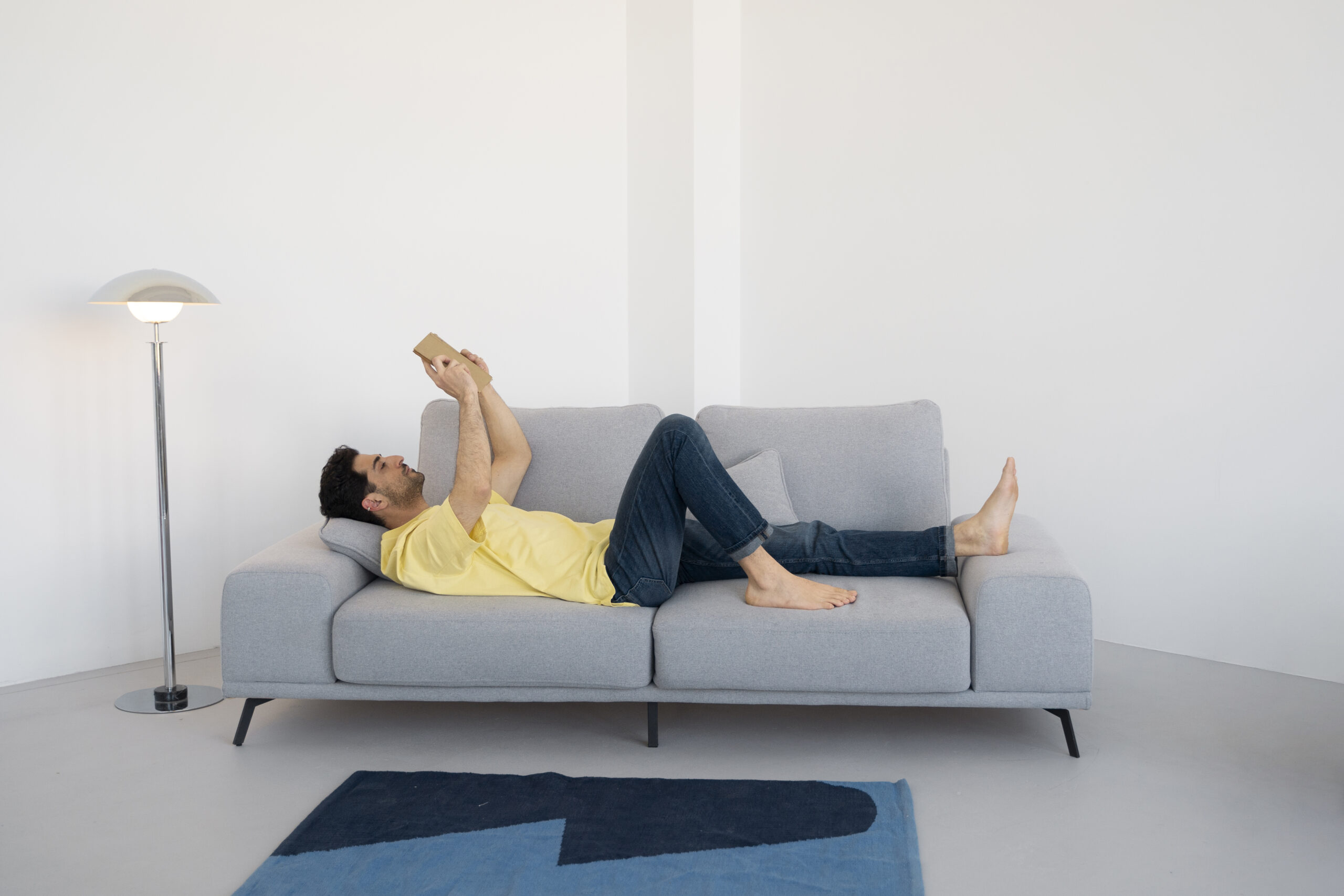 full-shot-man-reading-couch