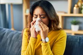 girl blowing her nose