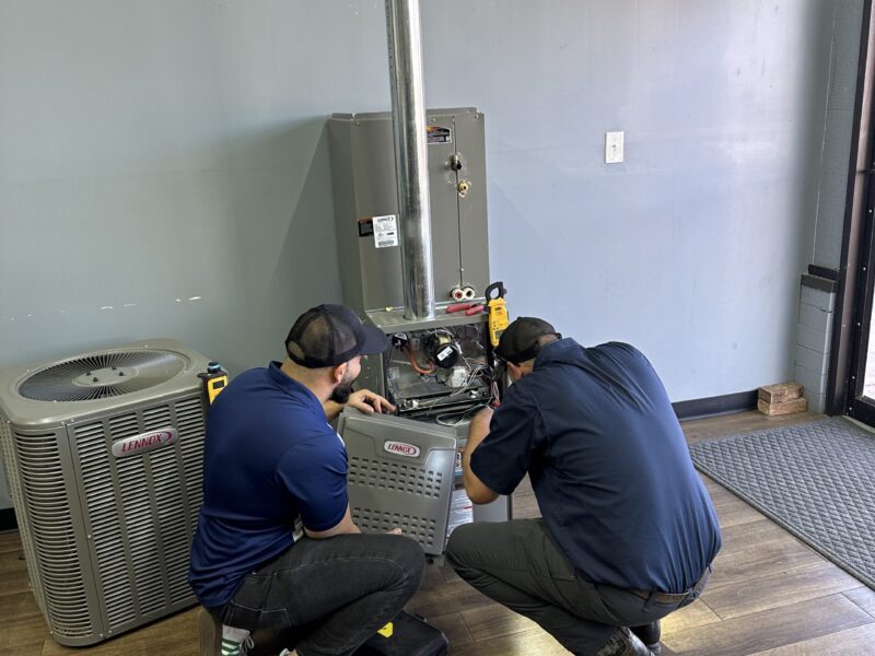 two men fixing unit